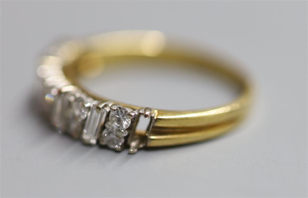 A modern 18ct gold, fives stone baguette and ten stone round cut diamond cluster set half hoop ring, size M, gross 2.8 grams,